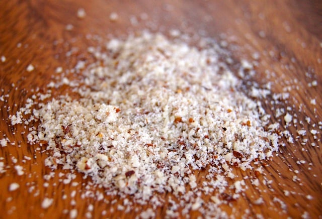 small pile of hazelnut flour on a wooden surface.