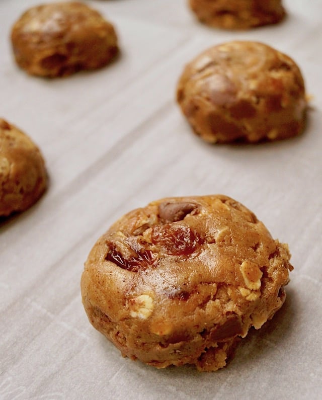 shaped oatmeal chocolate chip cooking dough on parchment paper