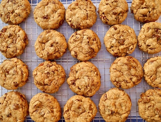 several oatmeal raisin chocolate chip cookies on a cooling rack