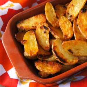 Cripsy Onion Fingerling Potatoes in a terra cotta dish