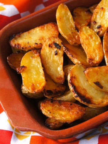 Cripsy Onion Fingerling Potatoes in a terra cotta dish