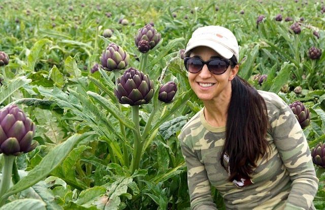 Valentina in a field of purple artichokes.