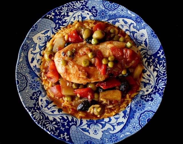 top view of cuban chicken stew in a blue and white bowl