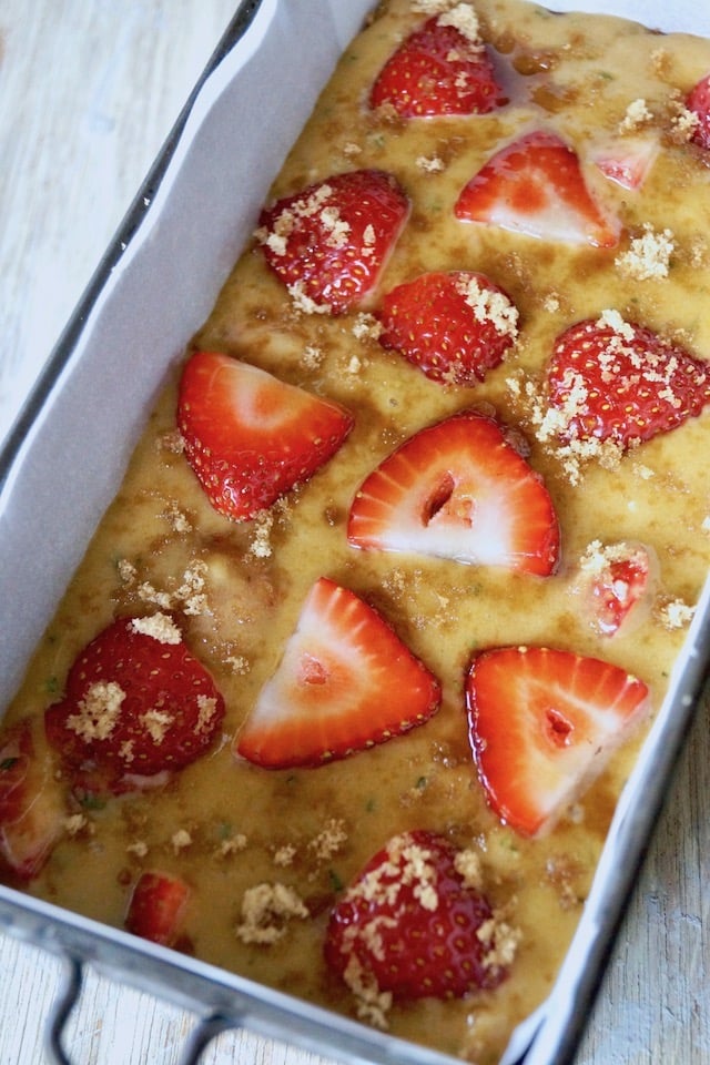 Raw Strawberry-Rosemary cake batter in loaf cake pan ready for the oven.