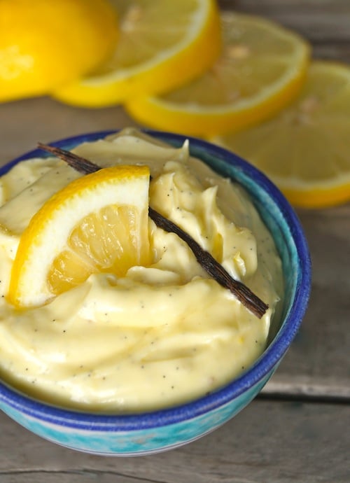 Whipped Meyer Lemon Butter in a small blue-rimmed bowl with vanilla pod on top.