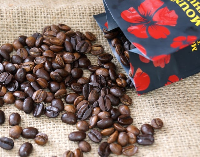 Coffee beans spilling out of coffee bag.