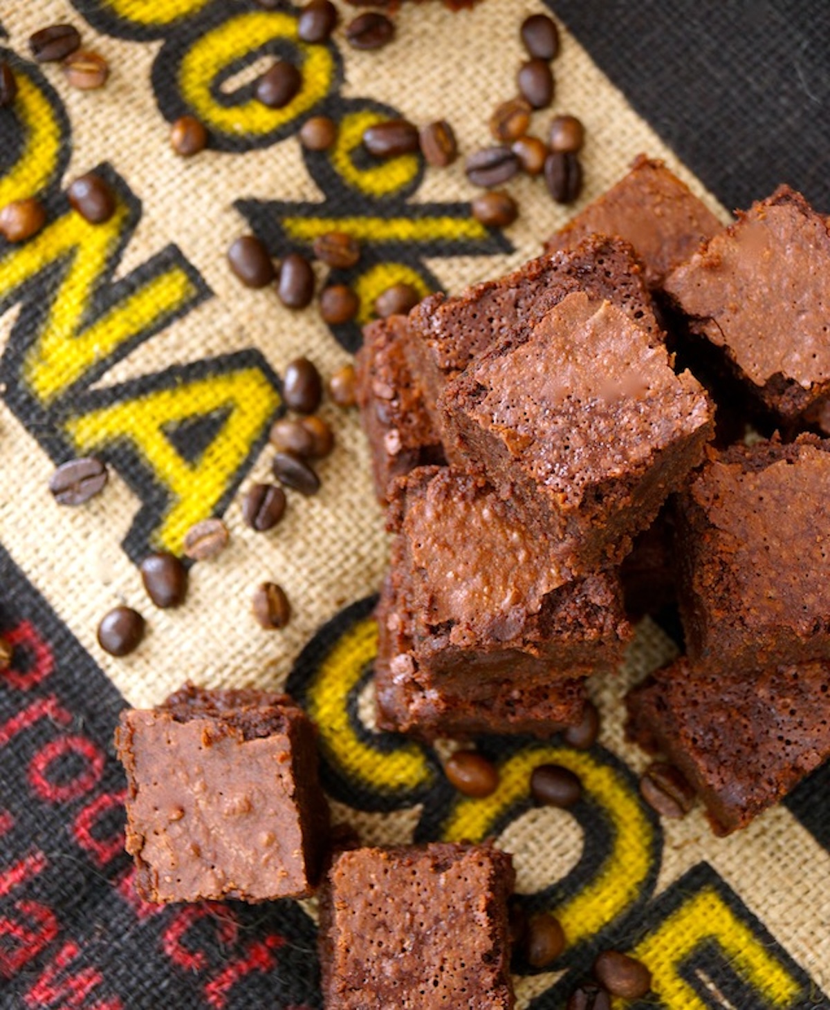 Coffee-Fudge-Brownies-with-Kahlúa Stack of square cut coffee brownies on a kona coffee burlap bag.