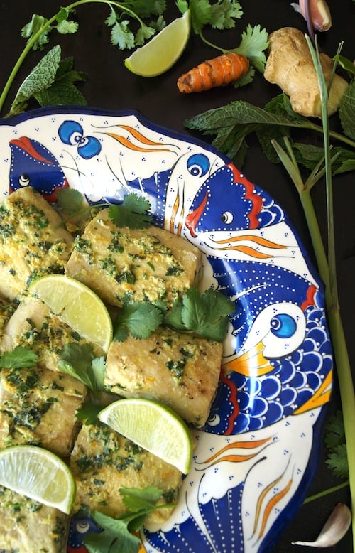 Thai Inspired Mahi Mahi Recipe on a gorgeous, ceramic plate with fish painted on the rim, to go with a Gai Lan recipe.