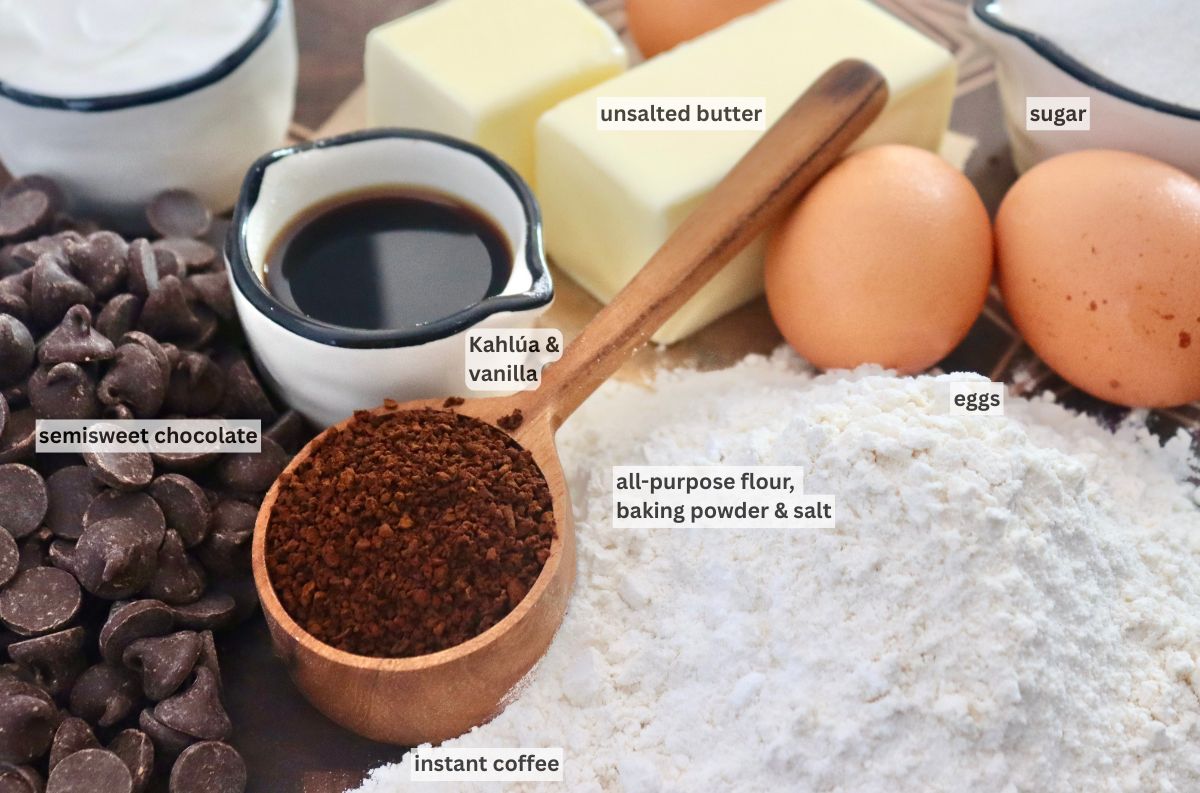 Flour, chocolate chips, eggs butter, coffee and kahlua on a cutting board.