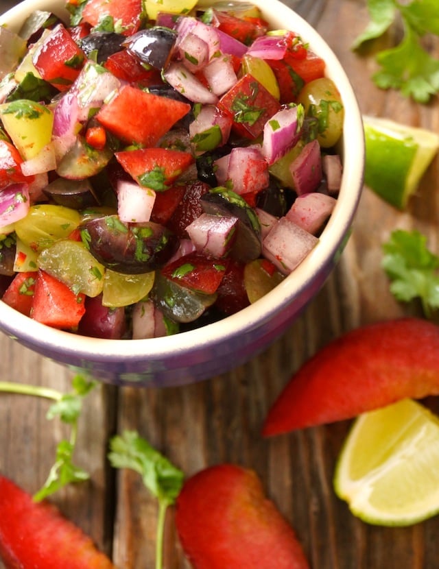 Grape-Plum Summer Salsa in a purple bowl on a wooden surface.