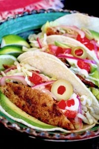 prepeared balckened fish tacos with spanish olive on top