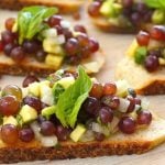 A few slices of a baguette with champagne bruschetta on top.