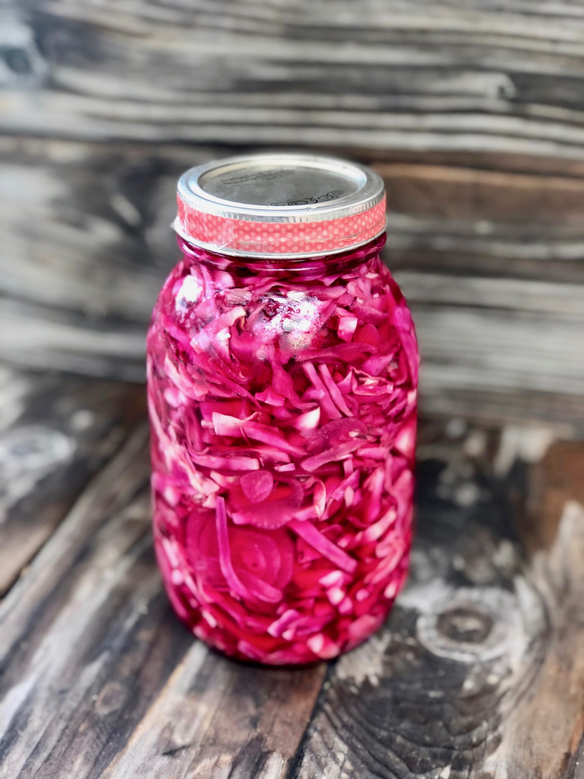Magenta pickled cabbage in Mason jar with lid