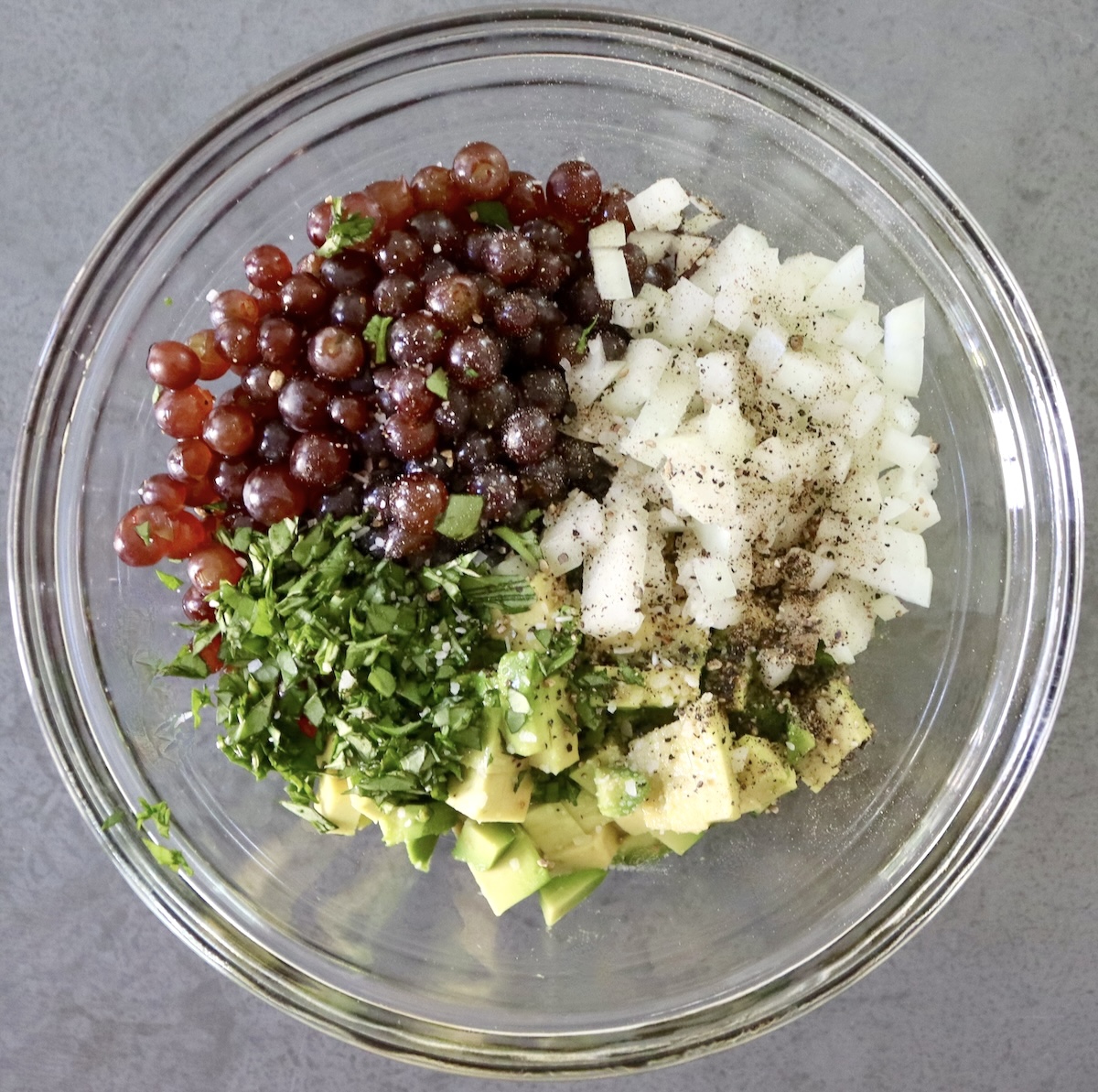 Ingredients for grape bruschetta in a glass bowl - not mixed. 