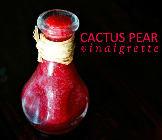 Small bottle of bright magenta prickly pear vinaigrette.