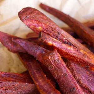 Chile Lemon Roasted Purple Sweet Potato Fries on parchment paper