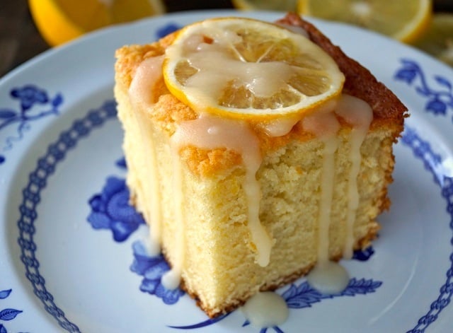 Slice of Lemon Hot Milk Cake on a white plate with blue flowers.