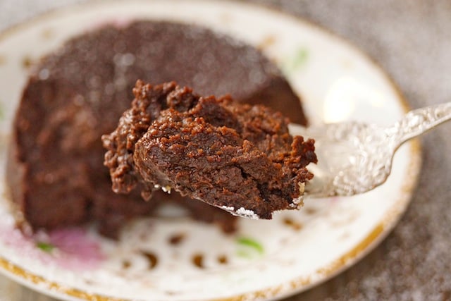 Flourless Chocolate Decadence Kahlua Cake with one bite on an antique silver fork.