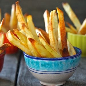 small ceramic, blue-rimmed dish with oven roasted french fries