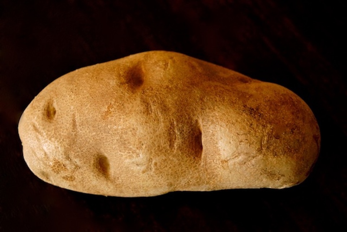 One whole Russet potato with skin on.