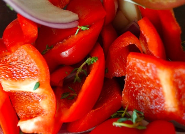 Bright red, roughly chopped red peppers with fresh thyme