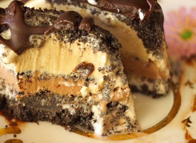individual coffee mud pie, with bite takend out to expose layers of ice creams and crust