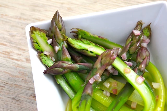 Purple Asparagus Recipe in a bright white, square dish.