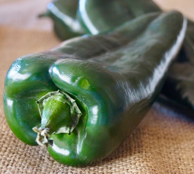 poblano peppers on burlap surface