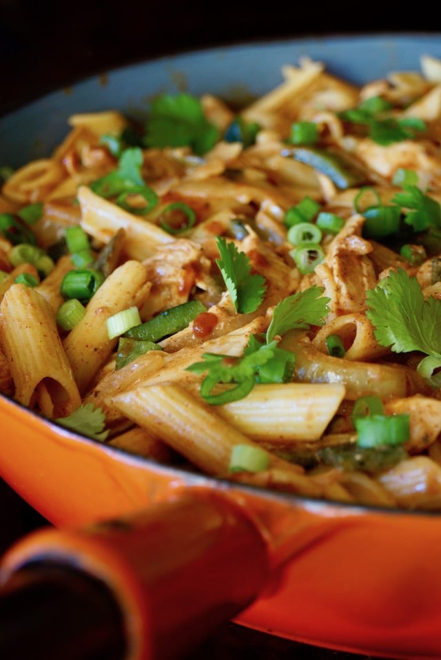 Close up of Mexican Chicken Poblano Pasta in a skillet with an orange handle