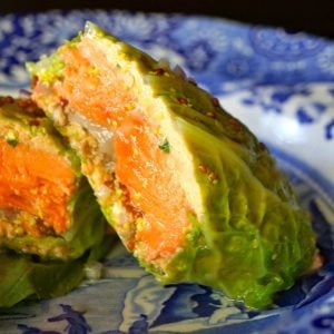 Salmon Stuffed Cabbage, sliced in half on blue plate