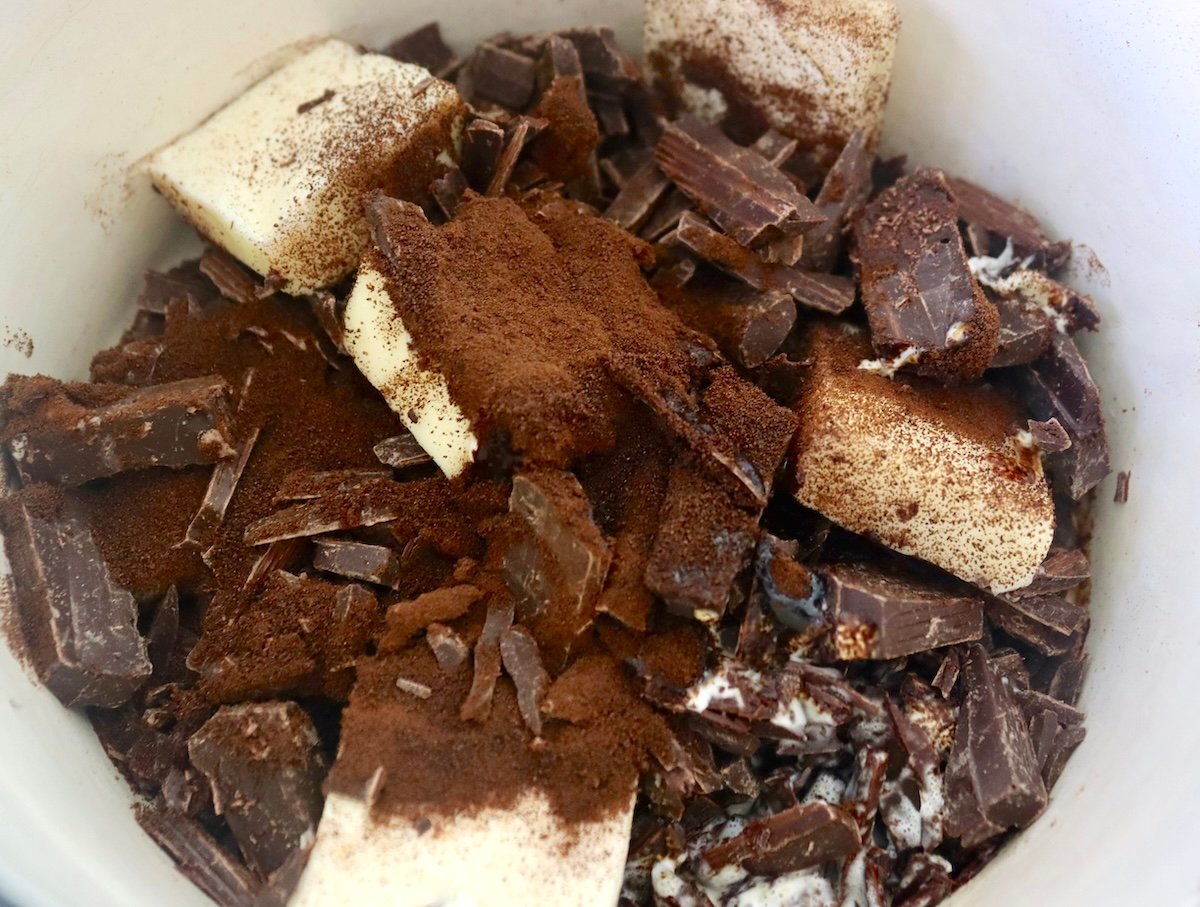 Small pot filled with chunks of butter, espresso powder and chocolate.
