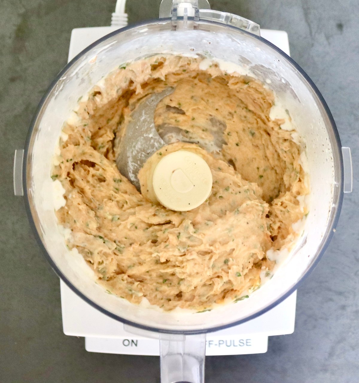 Salmon-and-Cabbage-Recipe Salmon mousse in a food processor bowl fitted with the blade attachment.