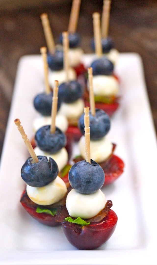 Mini Fruit Skewers on a rectangular white plate.