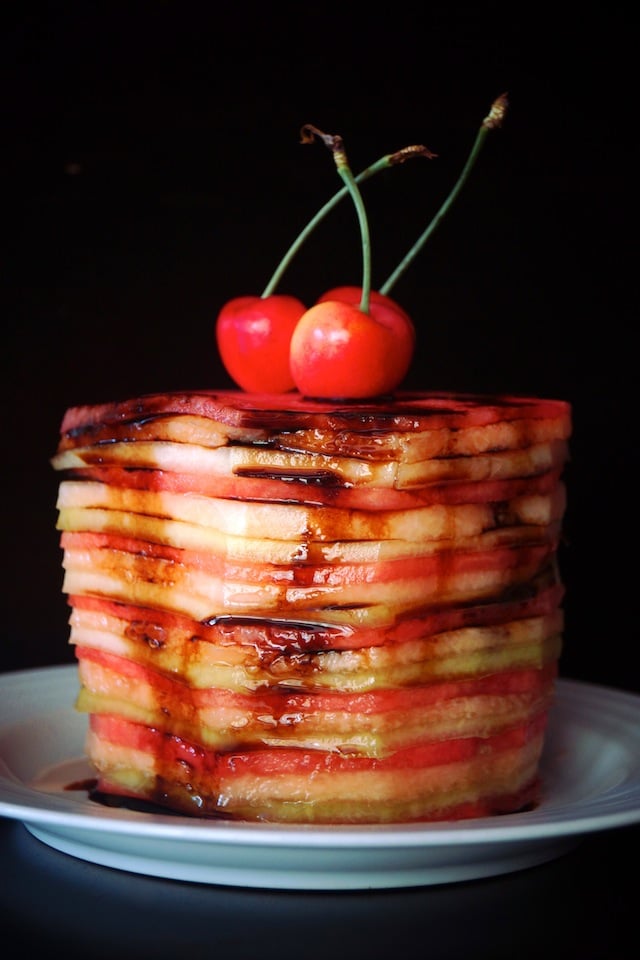 Fresh Melon Cake on a white plate with cherries on top