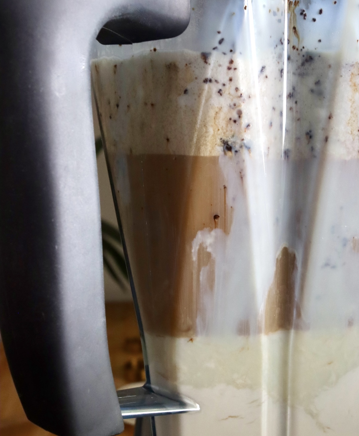 Side view of blender with ingredients for root beer float ice cream.