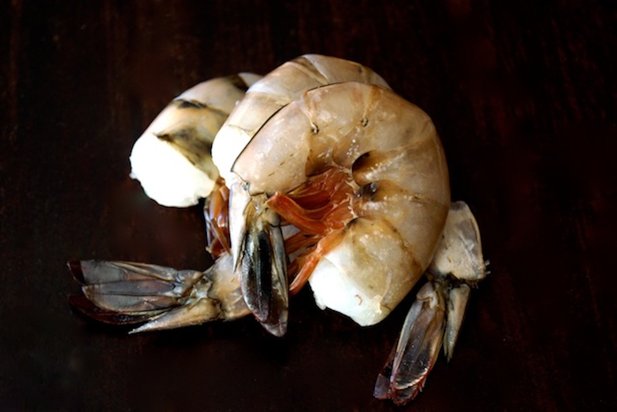 Two raw shrimp in their shells. 