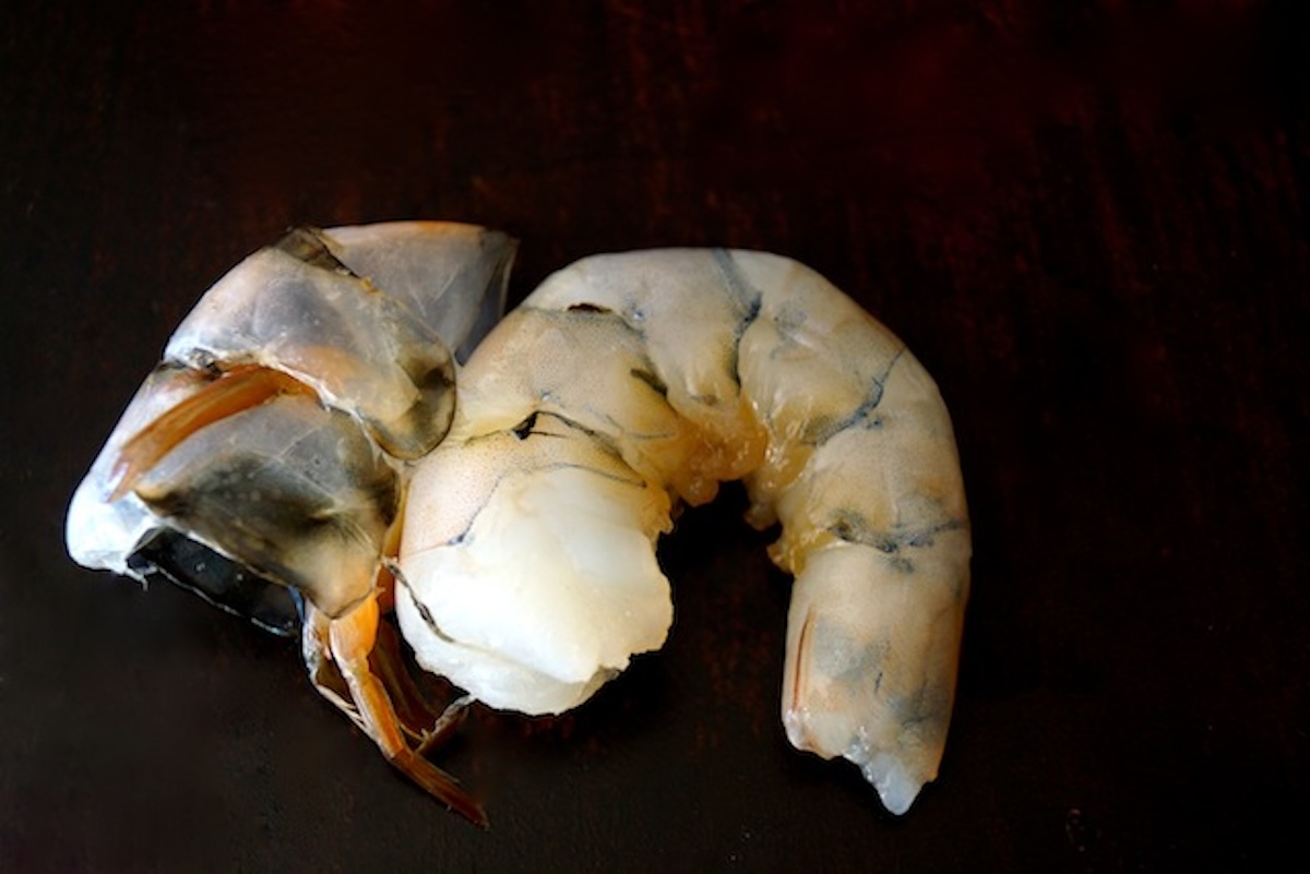 One raw shrimp with shell removed.