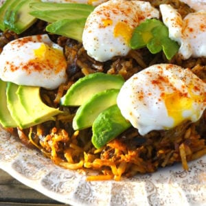 hash browns with poached eggs and avocado on top