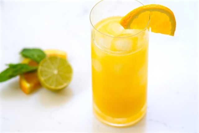 Spicy Mango Citrus Tequila Cocktail in a tall glass