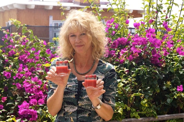 Cathy Arkle with two strawberry drinks in hand