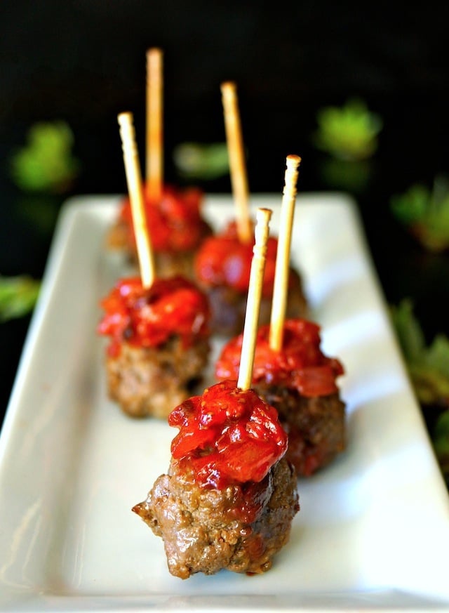 Smoky Strawberry-Chipotle Compote with Bacon Meatballs on narrowl white plate with toothpicks