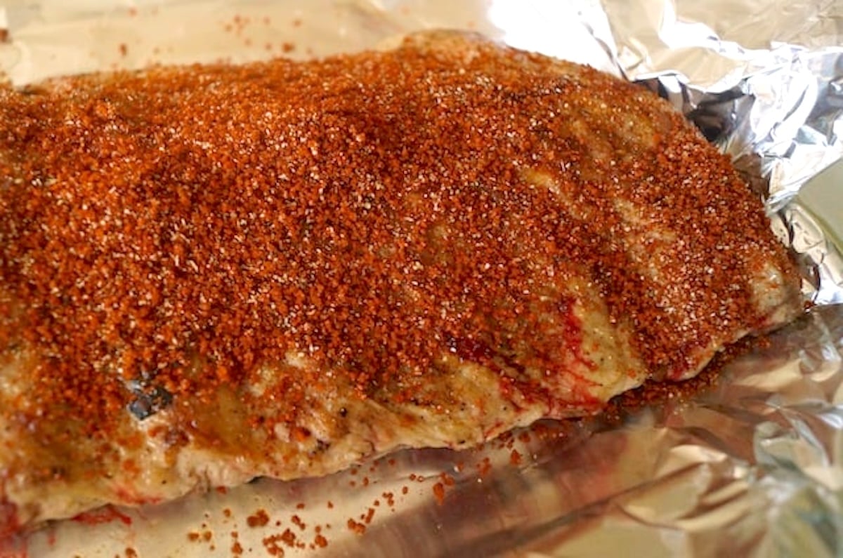 Spare rib rack with dry rub all over it.