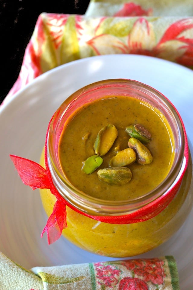 Jar of pistachio butter with a red ribbon