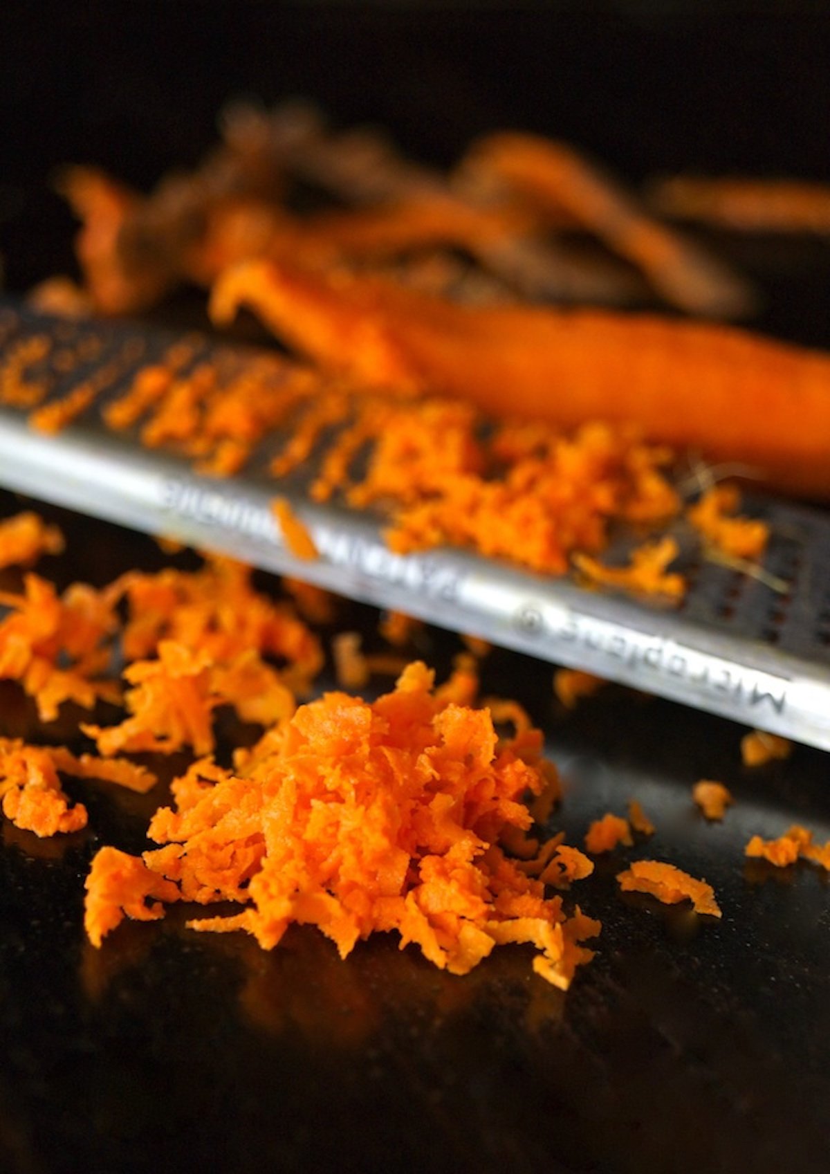 Pile of freshly grated bright orange turmeric rood with microplane zester.