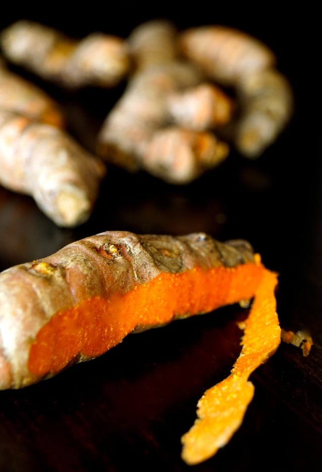 Fresh turmeric root with some of the skin peeled off