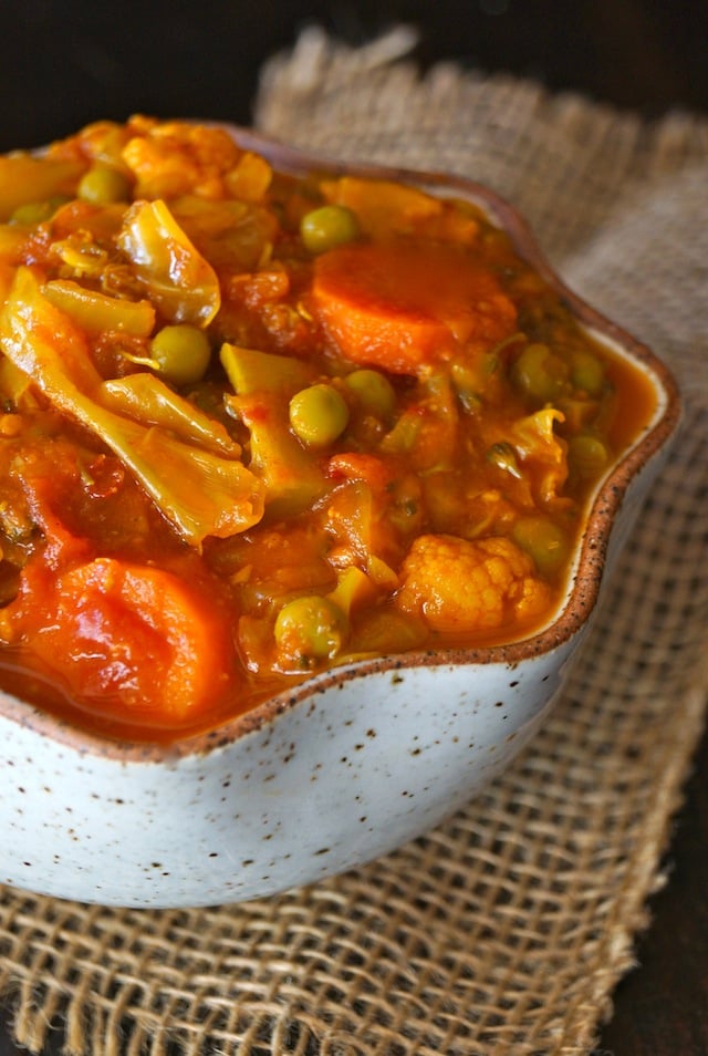 Turmeric Cabbage Stew is a curvy eggshell-colored bowl