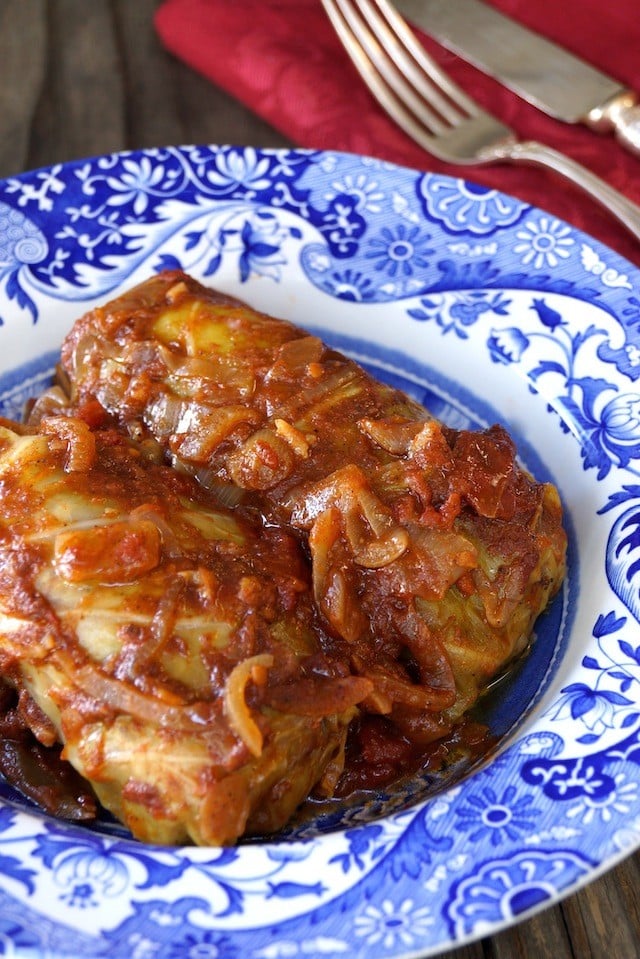 two Stuffed Cabbage rolls in a blue and white plate