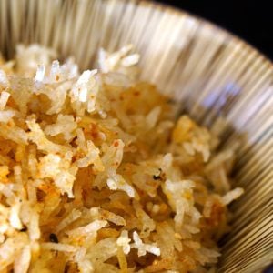 spicy crispy fried rice in a striped bowl