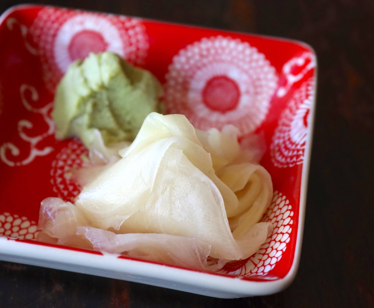 small red square bowl with pickled ginger and wasabi