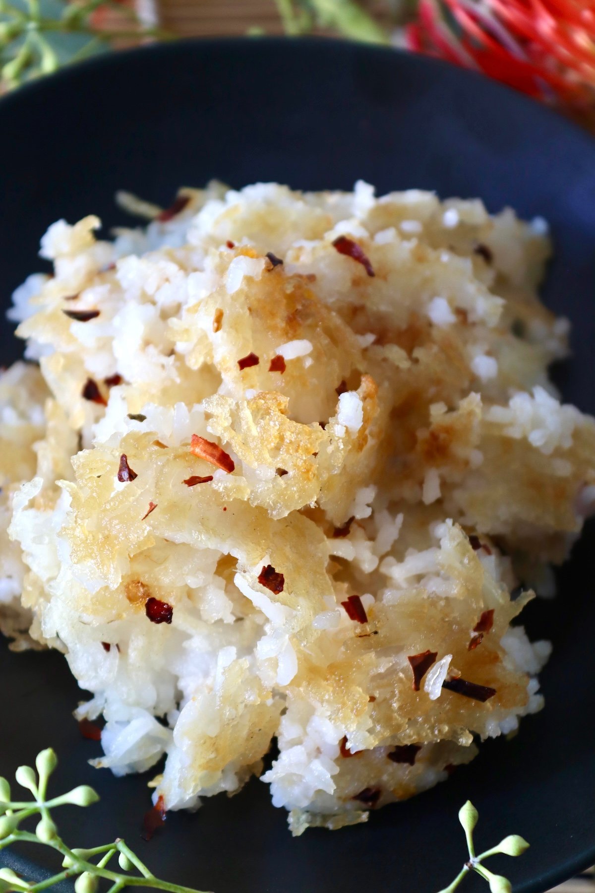 Close up of Close up of a crispy fried rice on a black plate.